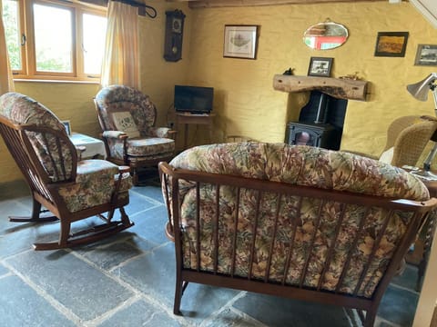 Living room with wood burner and slate floors