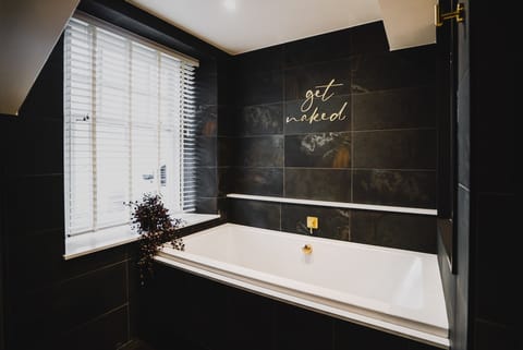 Deluxe Suite | Bathroom | Designer toiletries, hair dryer, towels, soap