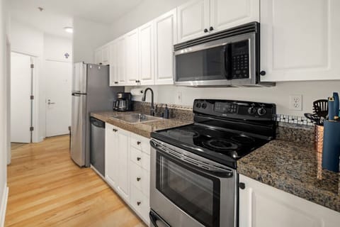 Stylish kitchen with granite countertops, stainless steel appliances, and all essentials for at-home cooking