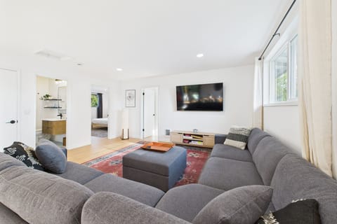 Spacious open living room on main level with 65" smart TV.