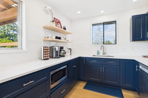 Coffee and tea bar includes a drip coffee machine, Kuerig, and hot water kettle