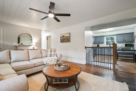 Gather in a bright open living room with a plush sectional, rustic coffee table, and warm wood floors. Just steps from the modern kitchen, it’s the perfect place to share meals and make memories together.