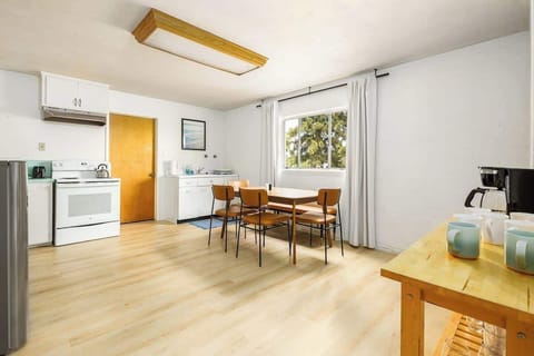 Sunny dining area with cool retro vibes, comfy seating, and a big window that brings the outdoors in, perfect spot for meals, coffee, or game night!