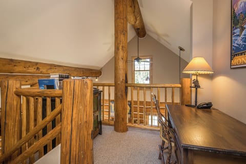 Loft leading to primary bedroom comes with desk and chair. | Upper Level