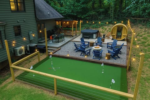 Catch a stunning view of your backyard playground — complete with a hot tub, sauna, firepit, bar, and putt-putt! The ultimate outdoor escape is all yours to explore!