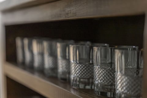 Elegant glassware neatly displayed on wooden shelving   - Ready for cocktails or refreshing drinks during your stay   - Thoughtful touches add comfort and convenience throughout