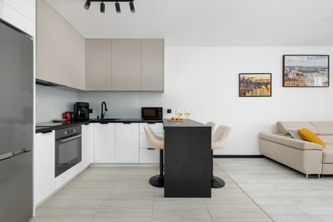 L-shaped kitchen connected to the living room with a center island.