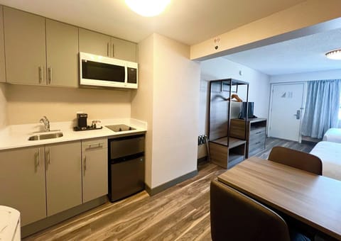 Deluxe Room, 2 Queen Beds, Kitchenette | Living area | 32-inch TV with cable channels