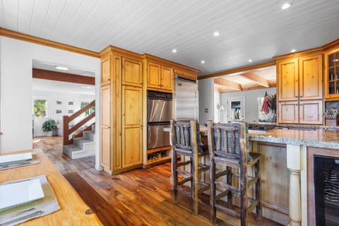 Fully stocked kitchen with stainless appliances.