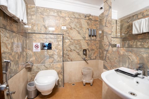 Deluxe Room | Bathroom | Shower, designer toiletries, hair dryer, slippers