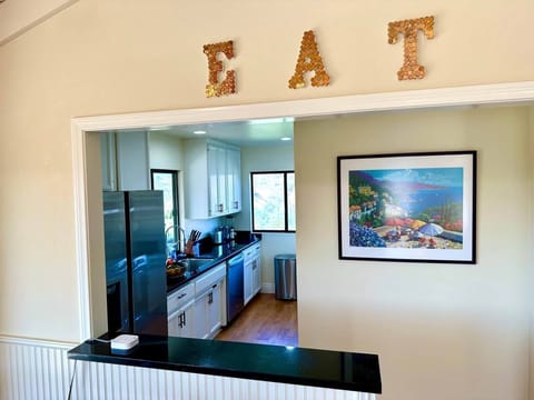 Penthouse Cottage: Open concept kitchen connects to living room.