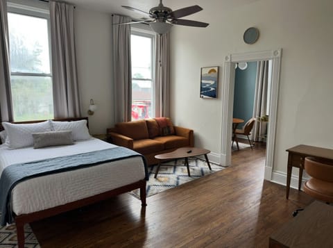 Main room with queen bed and living area with downtown views