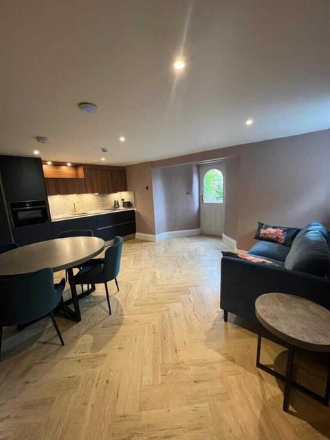 Unwind in the spacious living room and diner of the Wordsworth Apartment, featuring a full kitchen with Neff appliances, allowing you to relax and feel at home with the luxury and convenience of top-tier amenities.