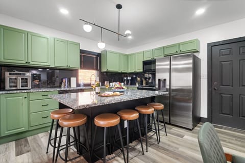 Fully stocked kitchen with large island — perfect for cooking & gathering.