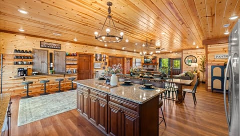 The main living space in the home has a spacious kitchen, dining table, beverage bar, and cozy living room!