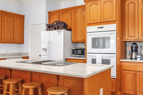 Stove top island with double ovens.