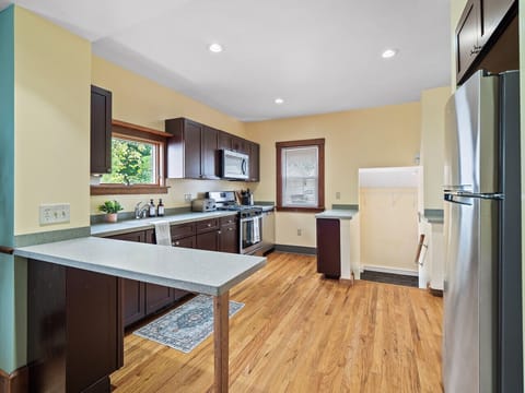 Bright kitchen with stainless steel appliances, lots of counter space & natural light 🍳🌿✨