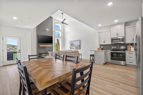 Open-concept kitchen, dining, and living area designed for gathering and entertaining.