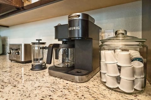 Fully stocked coffee bar. Keurig, coffee pot, and french press.