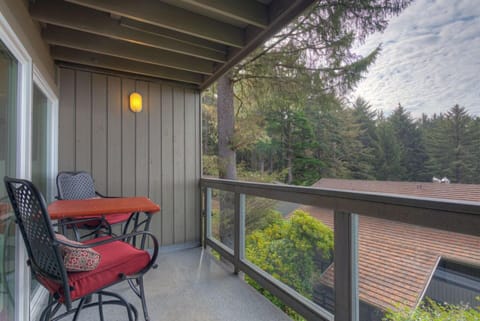 Step onto the private balcony, where a charming table and chairs await, perfect for enjoying the peaceful ambiance of the surrounding forest.