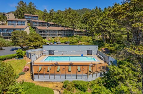 Nestled amidst towering trees, the heated pool area complements the resort's inviting atmosphere, perfect for a memorable getaway.