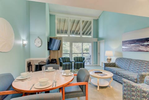 The dining area and living space are perfectly designed for relaxation and gatherings, offering easy access to the balcony with forest views.