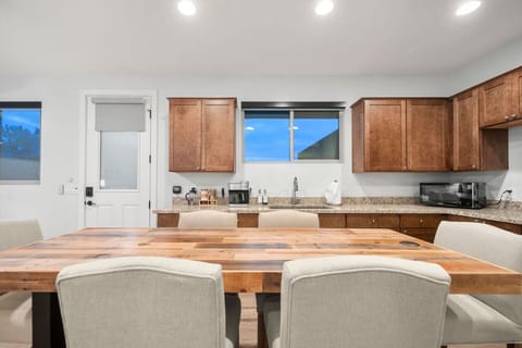 Open kitchen with scenic views and modern wooden table top