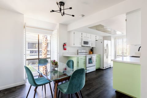 Bright kitchen and dining area with modern glass dining table