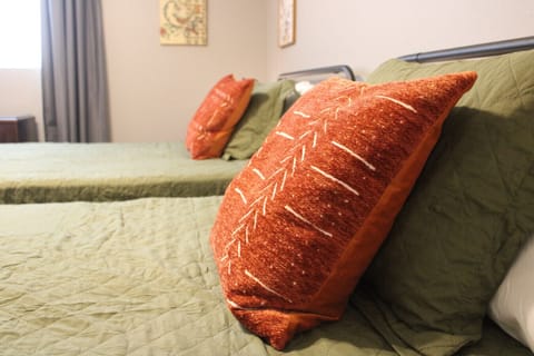 Inviting Guest Room: Features vibrant pillows and comfortable beds for refreshing nights.