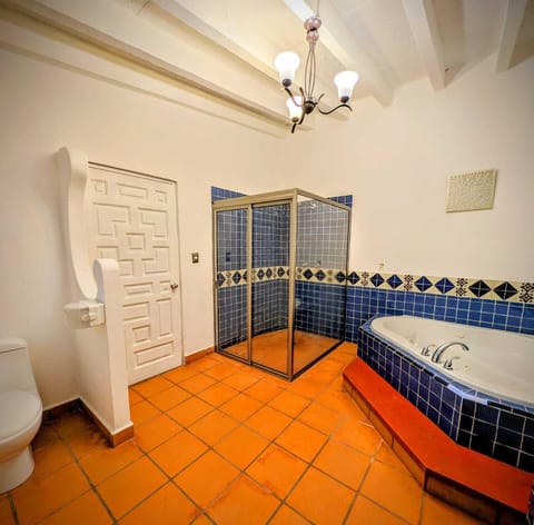 Deluxe Suite, Garden View | Bathroom | Separate tub and shower, hair dryer, towels, soap