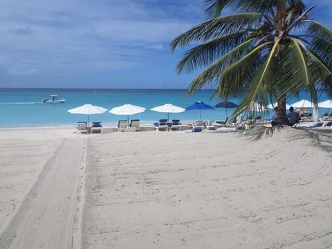 On the beach, white sand, sun loungers, beach towels