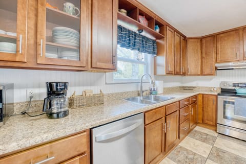Cook up your dreams in this charming kitchen! With beautiful wooden cabinets and a sleek white dishwasher, it's the perfect space for culinary adventures. 🍽️