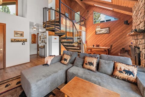 Living Room - Living Room with flat screen TV, comfy couches, vaulted ceilings, and partial lake views