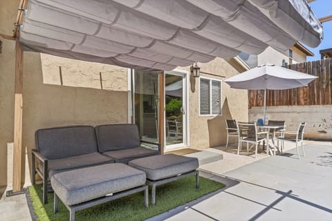 Outdoor patio area, featuring lounge chairs and a dining area
