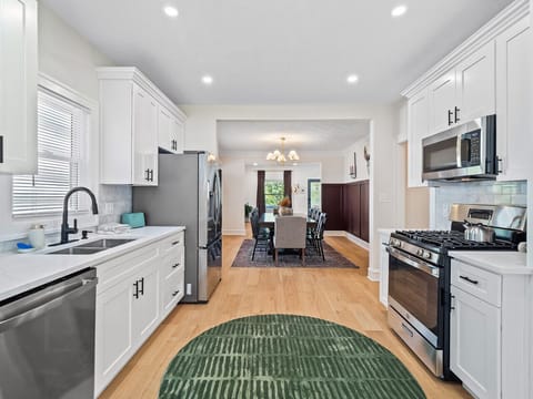 Open kitchen seamlessly connected to the dining area, featuring updated appliances, ample storage, and everything needed for home-cooked meals.