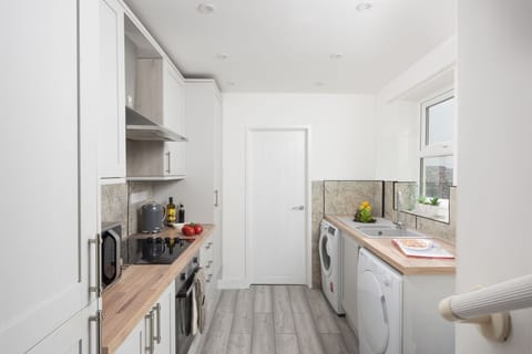 Cooker and hob, microwave, fridge/freezer, kettle, toaster and a range of pans and utensils, washing machine and tumble dryer