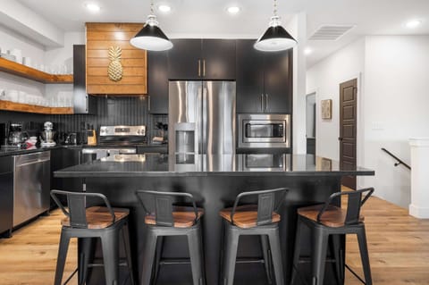 The chic, open kitchen offers ample space & every home comfort