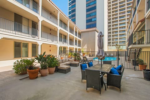 Communal outdoor gathering area with seating and BBQ