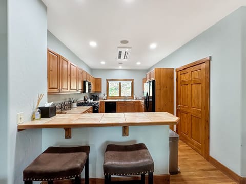 Step into this chef-friendly kitchen with island bar seating for two. Notice how the open design keeps you connected to family conversations while providing ample space to move freely - cooking becomes part of the gathering