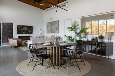 {Glass House Dining} A dramatic round dining table and warm modern design invite everyone to sit, share, and slow down