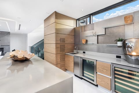 Gourmet chef`s kitchen featuring designer cabinetry, built-in beverage storage, and spacious counters