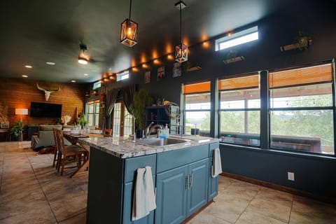 From preparing meals at the kitchen island to enjoying the dining table and relaxing in the living room, this open-concept space blends comfort and style.