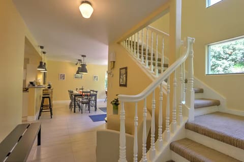 Window-lined stairwell to second level seating area and bedrooms