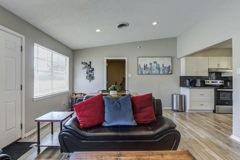 Open living area: sunlight, sofa, TV & dining.
