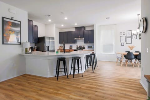 Fully equipped kitchen with sleek black cabinets and stainless steel appliances, ready for cooking or entertaining.