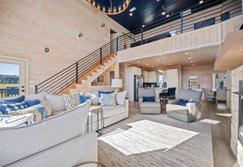 Open-concept living area with vaulted ceilings, modern furnishings, and plenty of natural light.