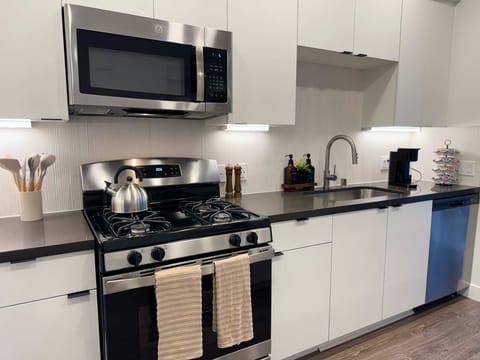 Experience extended comfort with a fully equipped kitchen featuring a coffee machine, stovetop, and microwave—everything you need for a seamless long-term stay.