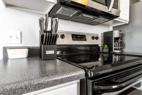 The stove, oven, and microwave are paired with a full knife set and coffee maker—everything you need for a seamless cooking experience.