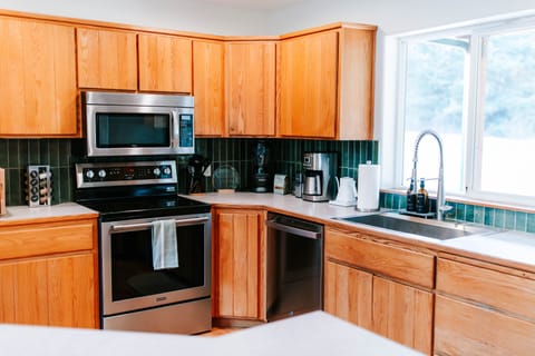 Spacious kitchen with modern appliances and everything you need to cook, gather, and share meals together.