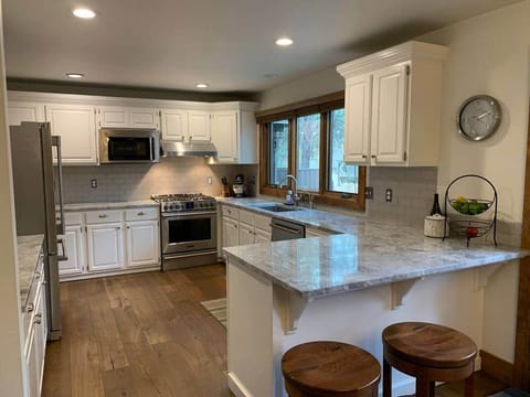 Updated kitchen with gas cooktop
Two swivel barstools for additional kitchen seating